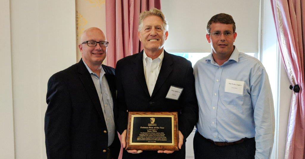 Three men with award