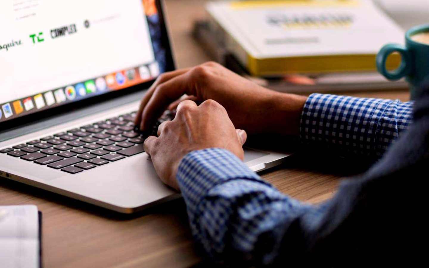 Male hands on laptop keyboard